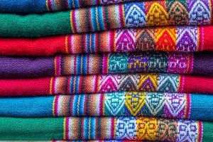 Background. Colorful set of alpaca scarves on the market in Lima.